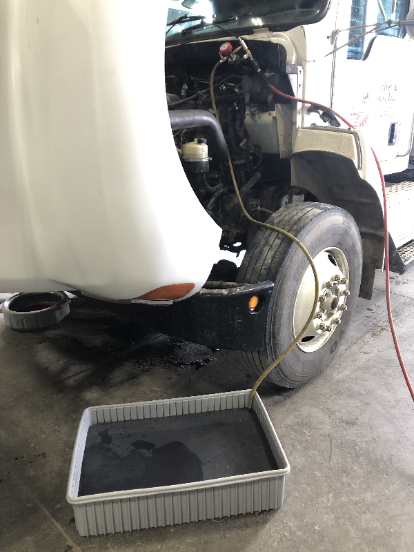 Vacuum tube in the corner of a Save-A-Spill container drawing fluid back into a truck