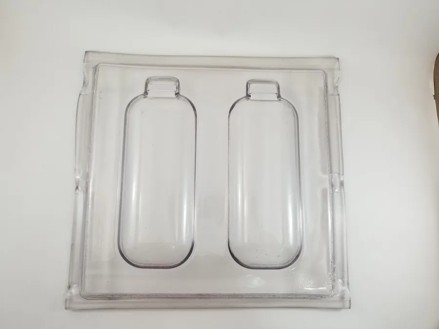 Clear custom thermoformed part with two formed pockets, made by Shirley K's