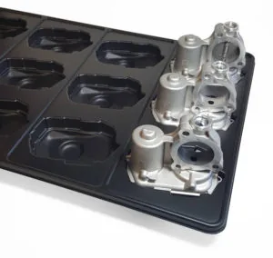 Reusable thermoformed dunnage tray from Shirley K's holding cast metal parts